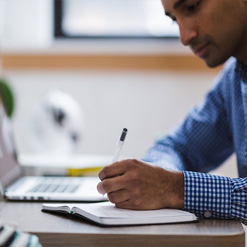 Man Writing and Studying